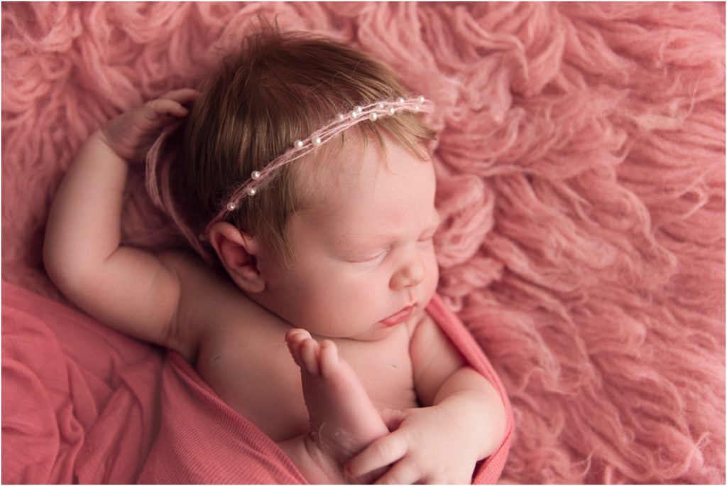 Blonde Haired Baby girl on pink backdrop Newborn Photographer Lima Ohio