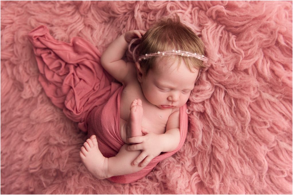 Blonde Haired Baby girl on pink backdrop Newborn Photographer Lima Ohio